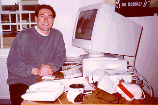 Rob, his desk and a fluffy pig