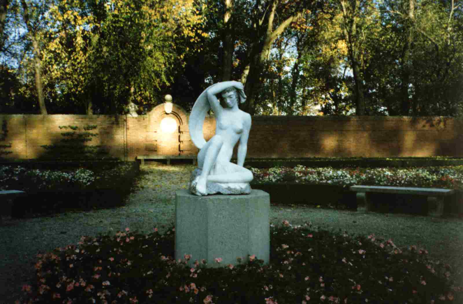 Walled garden with statue: 'Girl with a Scarf' by Lili Auer (German, c.1941)